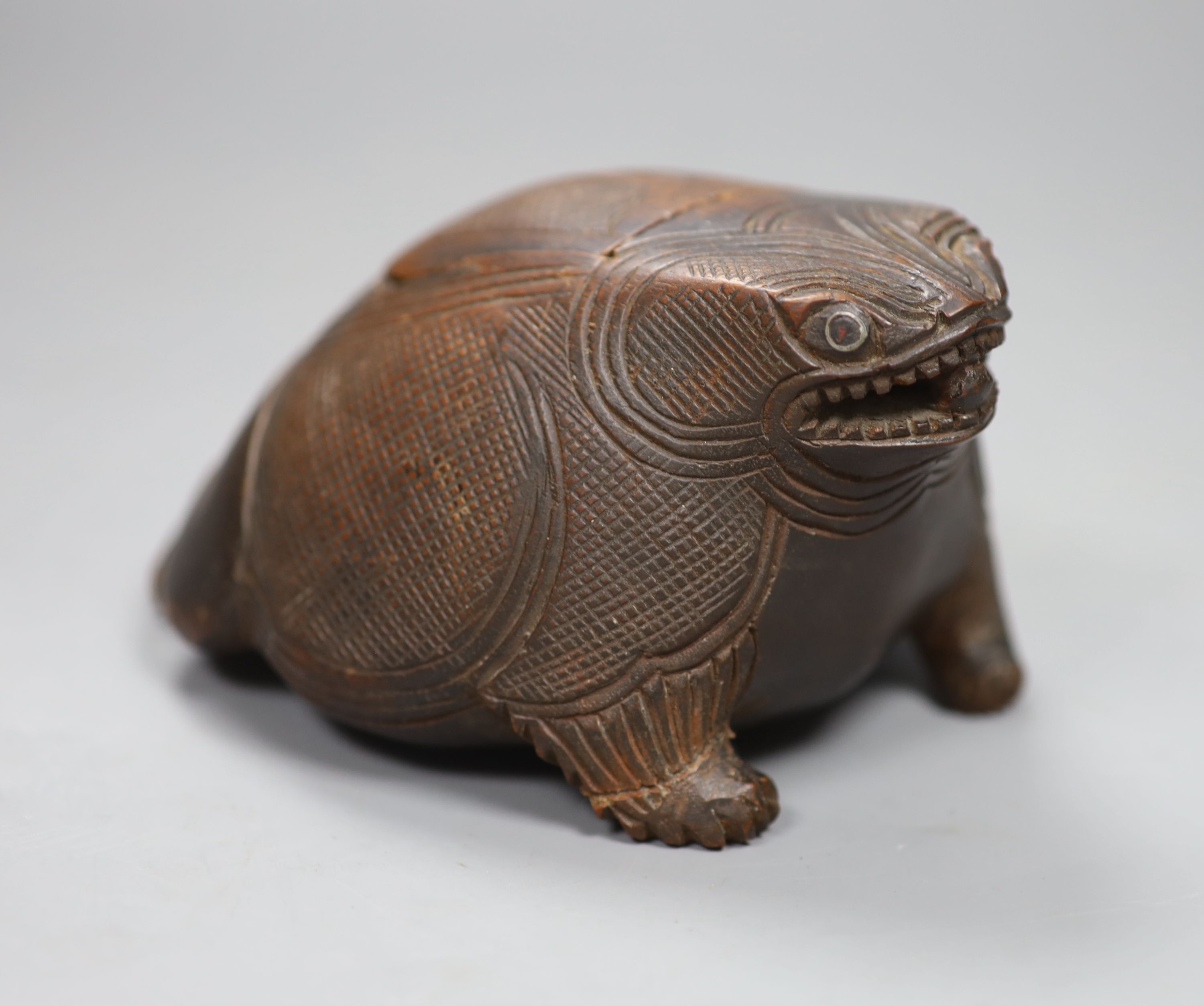 Ethnographica - a hardwood toad box and cover, 14cm long, metal ring inset eyes, warm brown patina